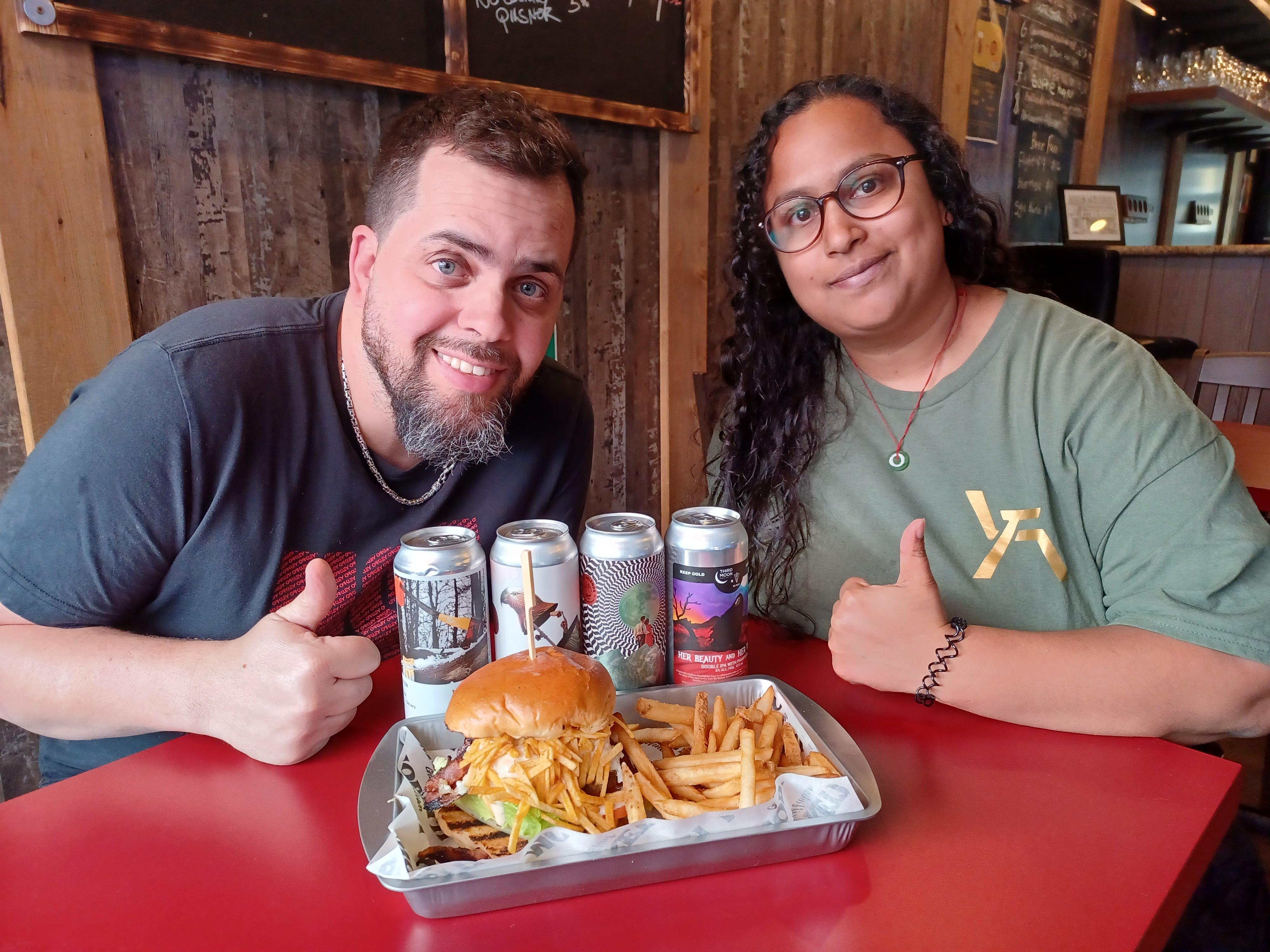 Couple with burgers and drinks for a date.